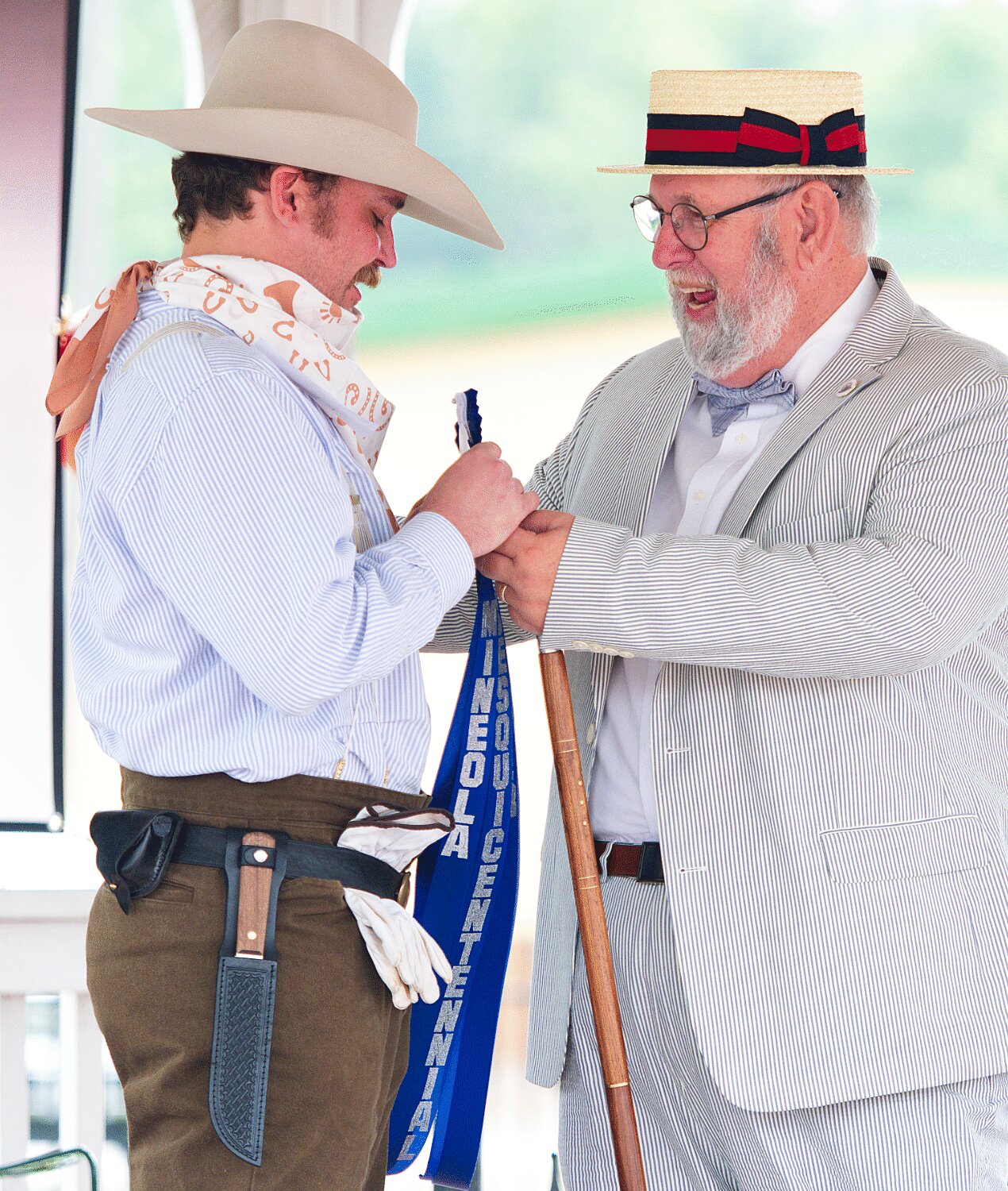 Logan Thompson receives a ribbon from Mr. Sesquicentennial Gordon Tiner for the best mens costume for his 1870s ensemble. [see so many more sesquicentennial spring fling photos]